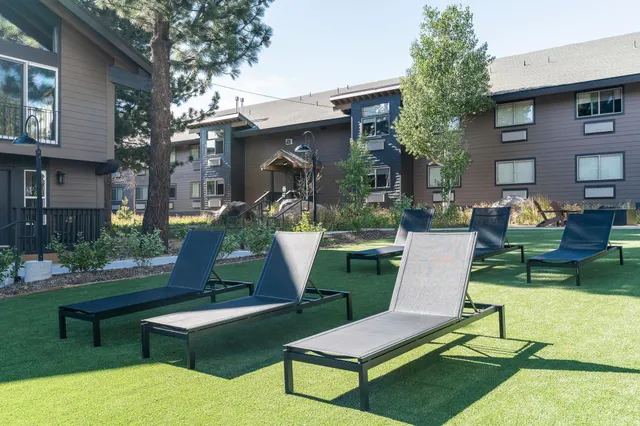 a front view of a house with garden and sitting area