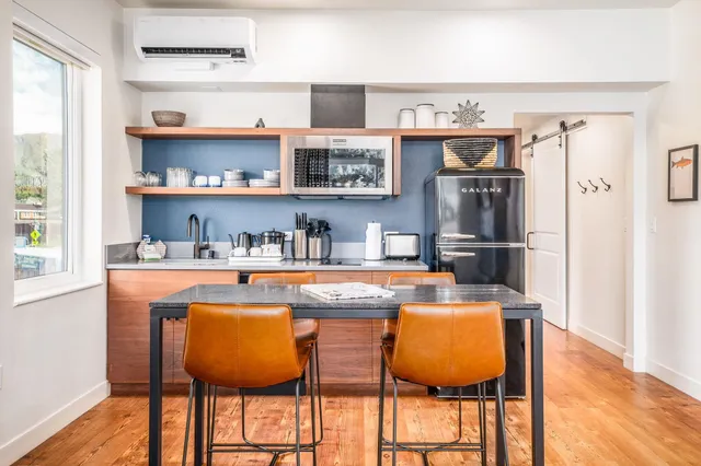 a dining table with chairs and cabinets