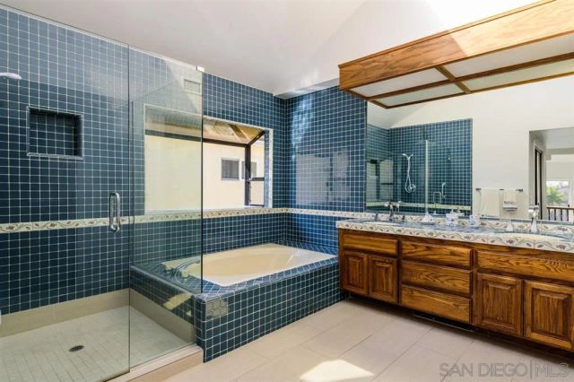 a bathroom with a tub a sink and a shower