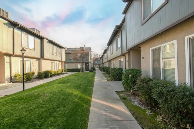 a view of a brick house with a yard