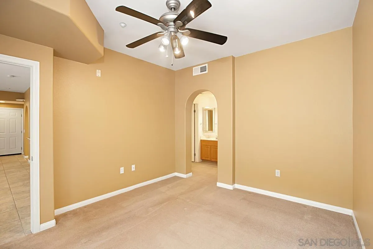 2715 Lake Pointe Drive, Unit 121 Spring Valley, CA 91977 - Photo 11 of 27 an empty room with closet and a chandelier fan