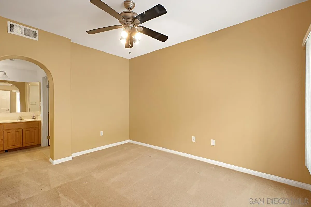 2715 Lake Pointe Drive, Unit 121 Spring Valley, CA 91977 - Photo 12 of 27 an empty room with a ceiling fan and a window