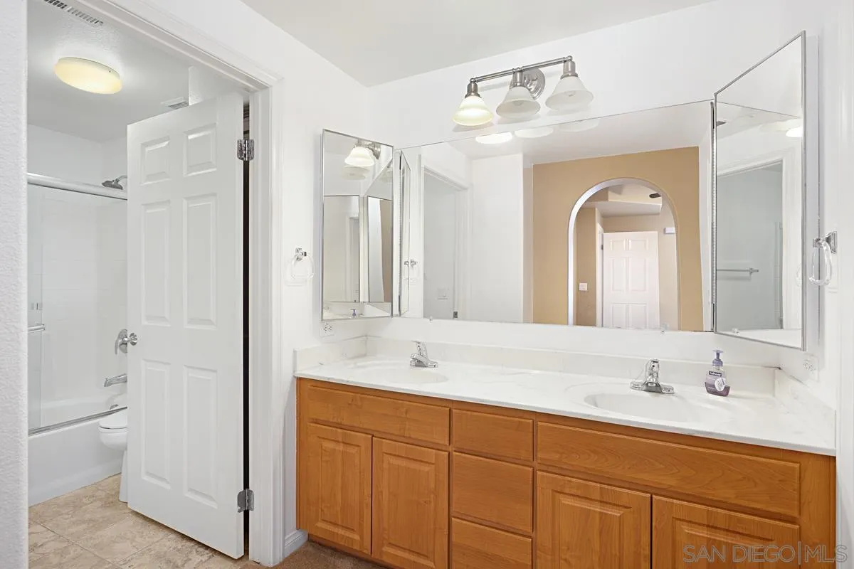 2715 Lake Pointe Drive, Unit 121 Spring Valley, CA 91977 - Photo 13 of 27 a bathroom with a granite countertop sink mirror and toilet