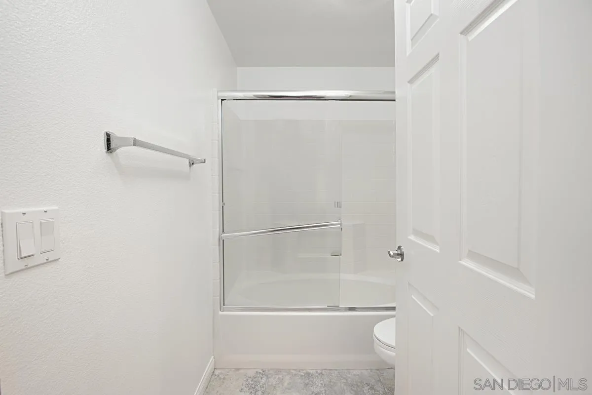 2715 Lake Pointe Drive, Unit 121 Spring Valley, CA 91977 - Photo 15 of 27 a bathroom with a glass shower door