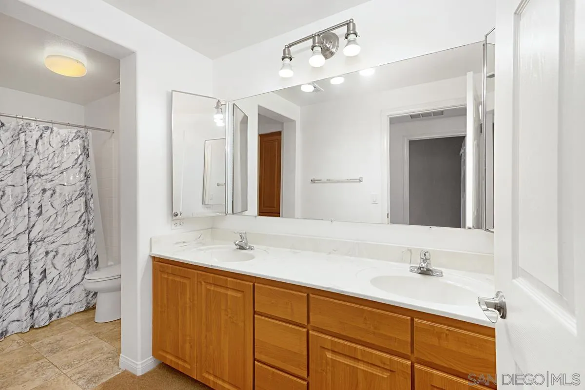 2715 Lake Pointe Drive, Unit 121 Spring Valley, CA 91977 - Photo 20 of 27 a bathroom with a sink and a mirror