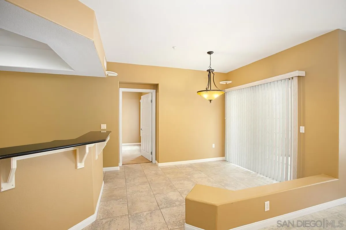 2715 Lake Pointe Drive, Unit 121 Spring Valley, CA 91977 - Photo 2 of 27 a view of a hallway with wooden floor and chandelier