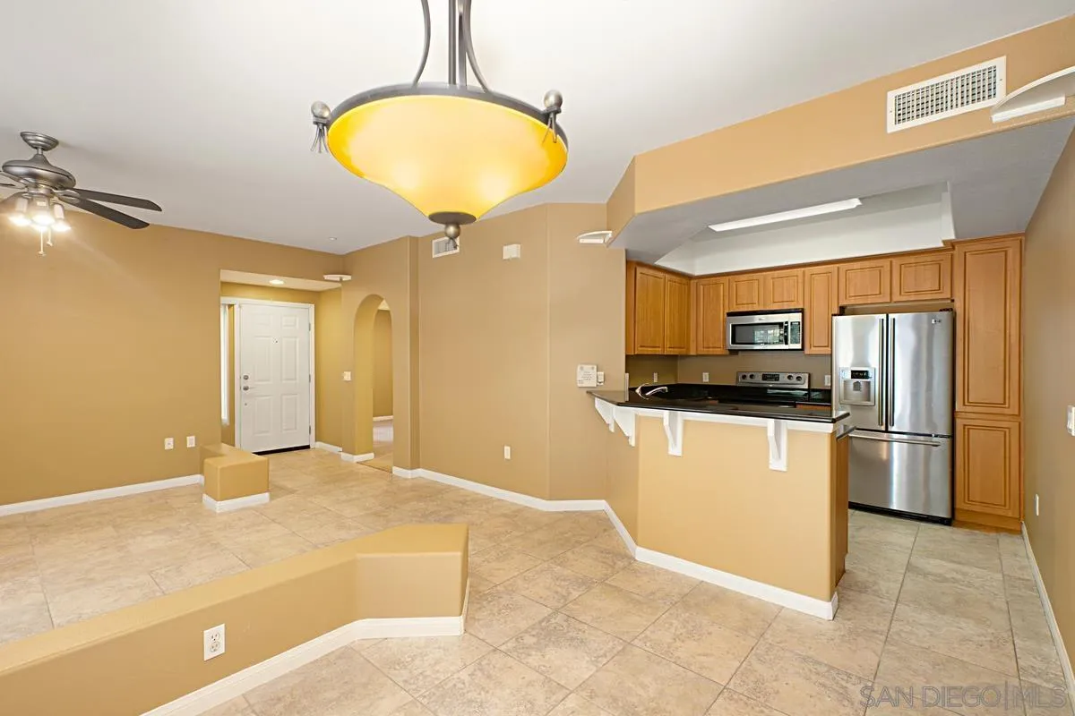 2715 Lake Pointe Drive, Unit 121 Spring Valley, CA 91977 - Photo 6 of 27 a view of a kitchen with a sink and dishwasher a refrigerator freezer