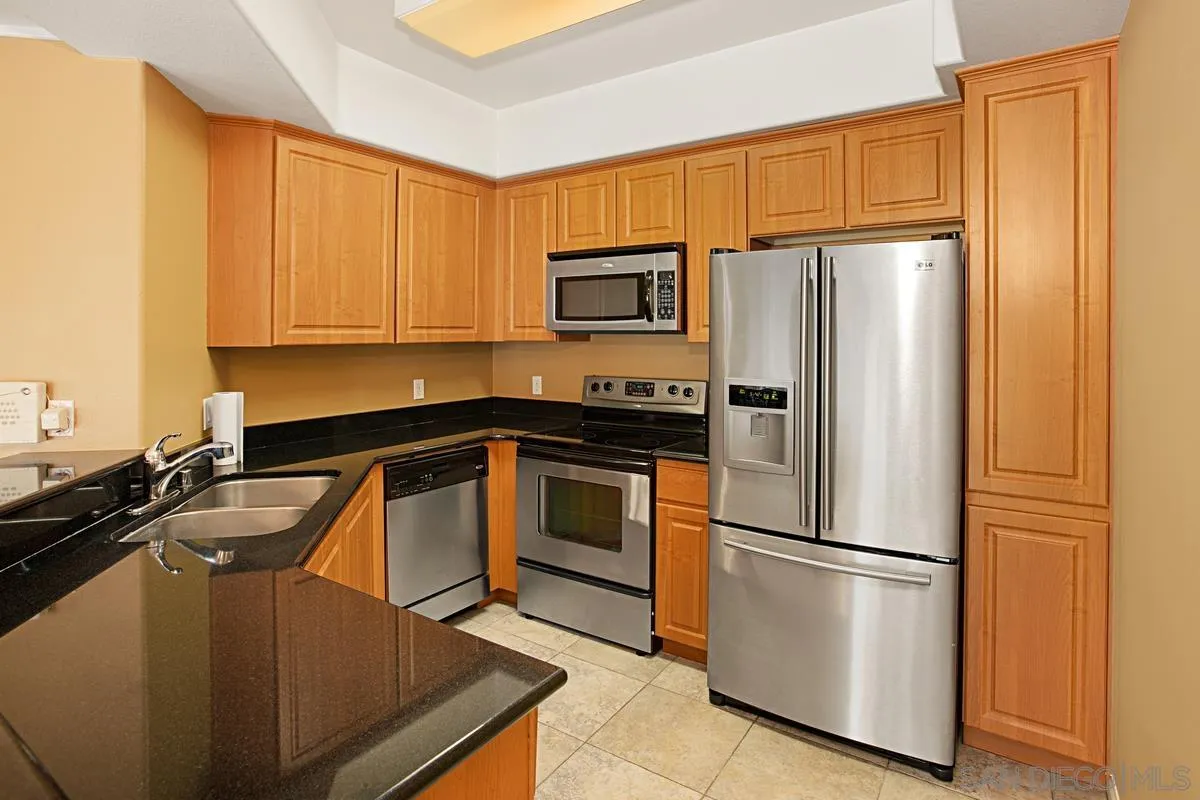 2715 Lake Pointe Drive, Unit 121 Spring Valley, CA 91977 - Photo 8 of 27 a kitchen with a refrigerator sink and microwave