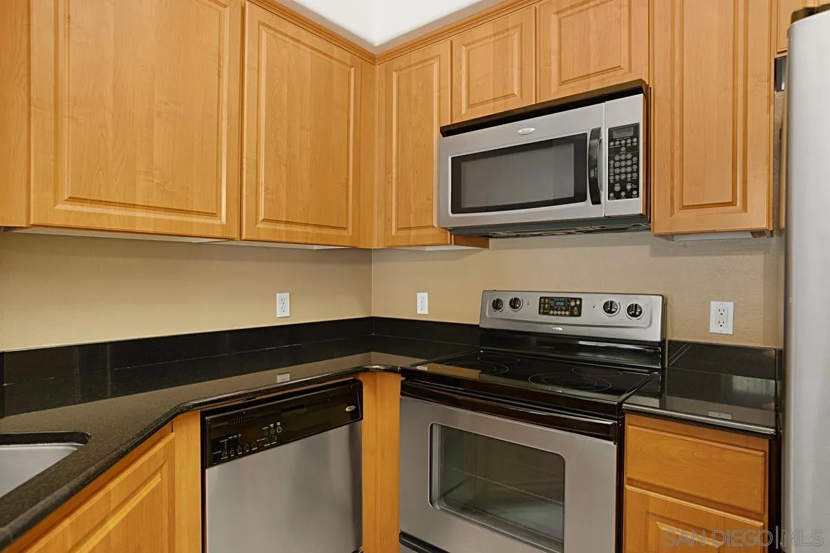 2715 Lake Pointe Drive, Unit 121 Spring Valley, CA 91977 - Photo 10 of 27 a kitchen with microwave stove and cabinets