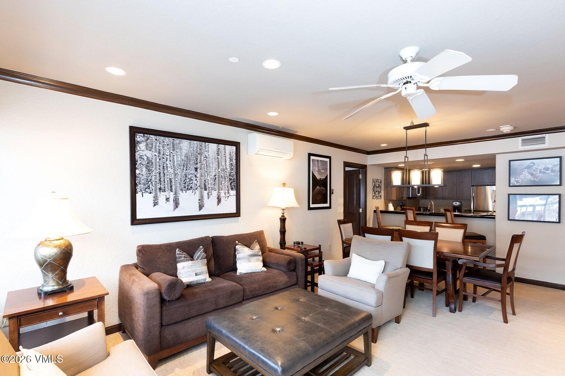 210 Offerson Road, Unit 2076 Beaver Creek, CO 81620 - Photo 1 of 27 a living room with furniture a chandelier and a dining table