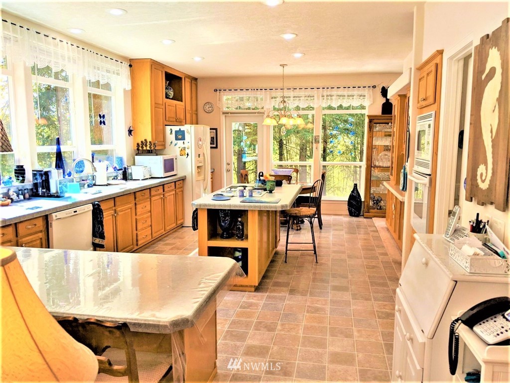 137 Smith Road Centralia, WA 98531 - Photo 11 of 39 a dining room with stainless steel appliances furniture a large window and a kitchen view