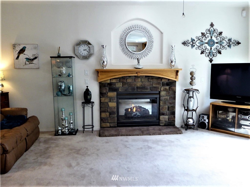 137 Smith Road Centralia, WA 98531 - Photo 15 of 39 a living room with furniture a flat screen tv and a fireplace