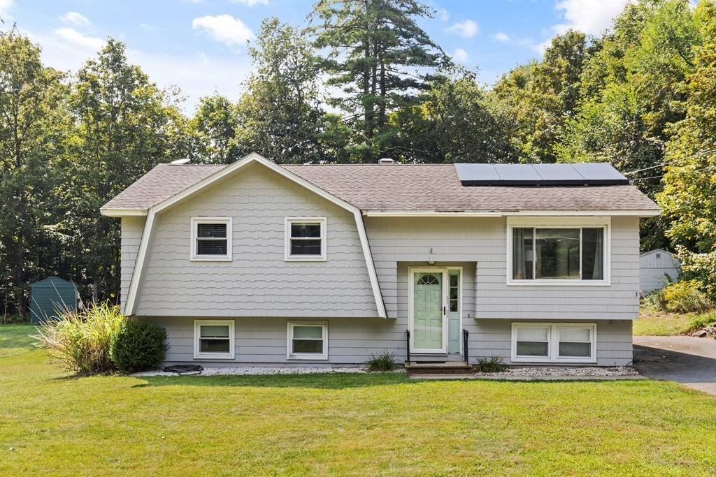 a front view of a house with a yard table and chairs