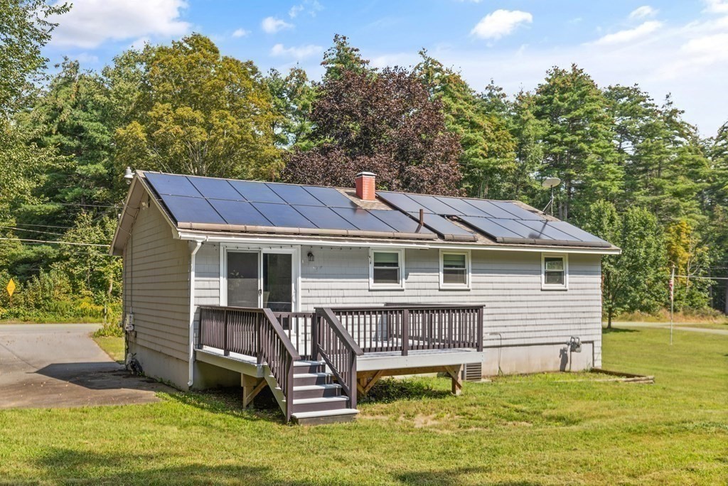3 Proctor Road Townsend, MA 01469 - Photo 16 of 19 a view of a house with a deck and a yard with green space