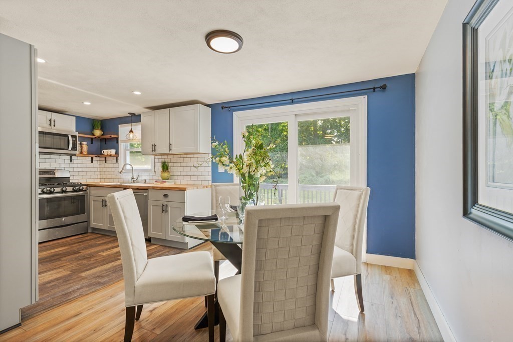 3 Proctor Road Townsend, MA 01469 - Photo 5 of 19 a kitchen with kitchen island a stove a table and chairs in it