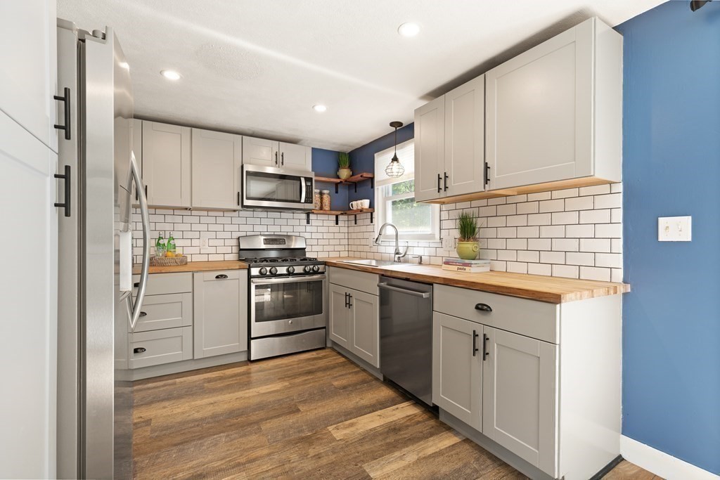 3 Proctor Road Townsend, MA 01469 - Photo 7 of 19 a kitchen with stainless steel appliances granite countertop a stove sink and cabinets