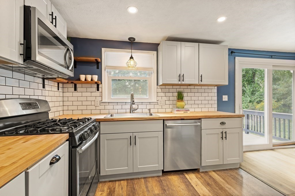 3 Proctor Road Townsend, MA 01469 - Photo 8 of 19 a kitchen with granite countertop a sink stove and cabinets