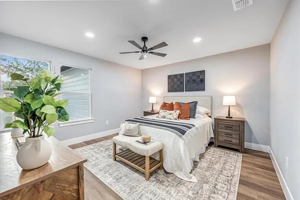 a bedroom with furniture and a potted plant