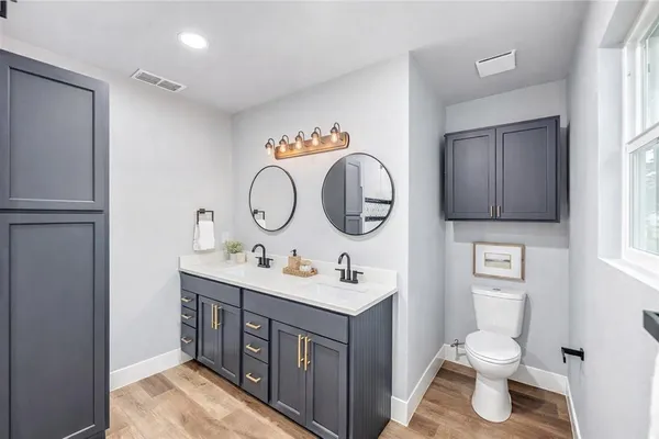 a bathroom with a toilet a sink and a mirror