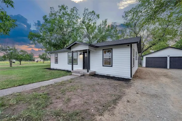 a view of a house with a yard and garage