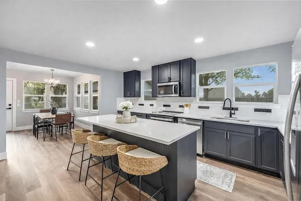 a kitchen with sink cabinets and dining table