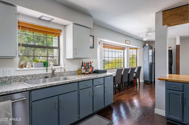 a kitchen with lots of counter top space and wooden floor