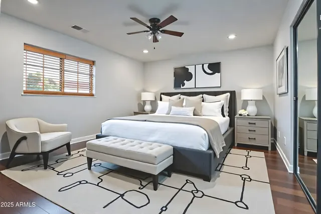 a bed room with a bed and a chair