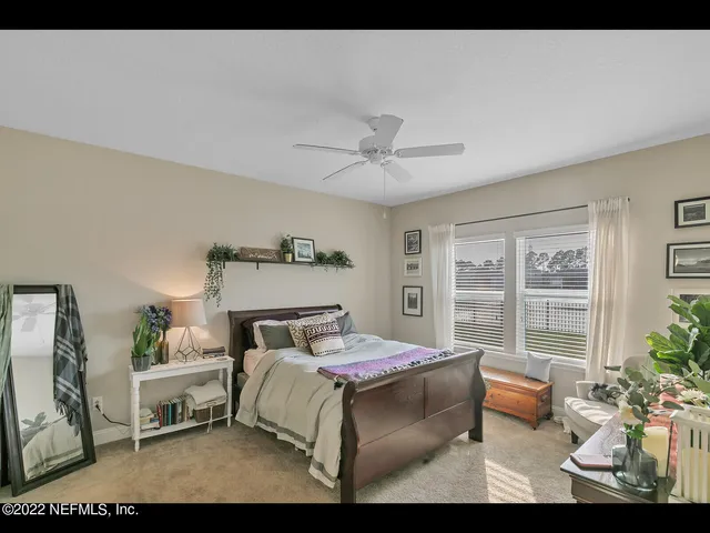a bedroom with furniture and a large window