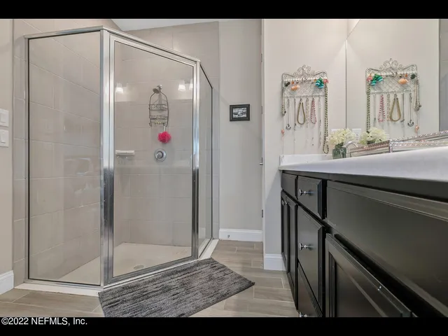 a bathroom with a shower sink and mirror