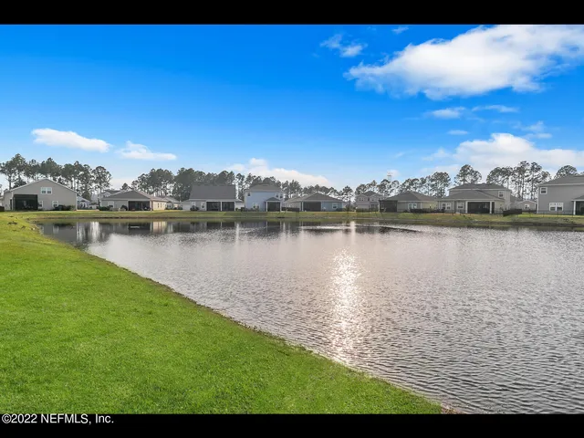 a view of a lake with houses in the back
