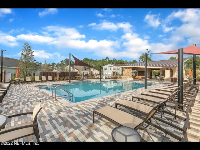 a view of swimming pool with outdoor seating