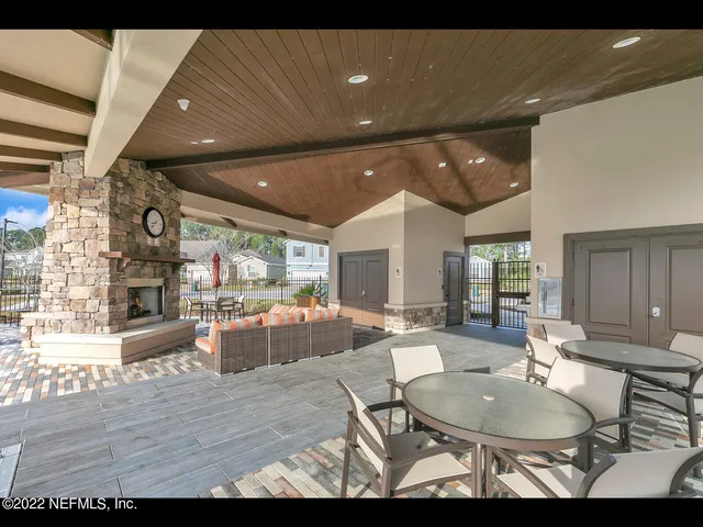 a living room with furniture a wooden floor and kitchen view