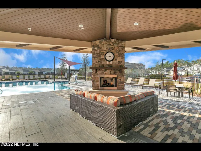 a large living room with fireplace furniture and a floor to ceiling window