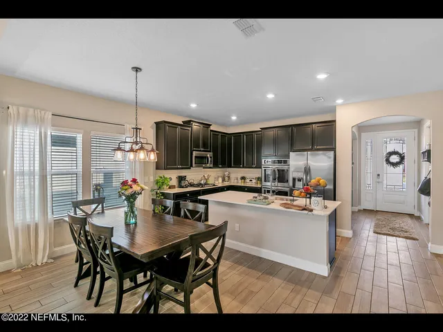 a kitchen with a table and chairs