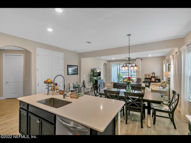 a kitchen with a table chairs and white cabinets