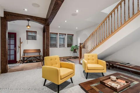 a very nice looking living room with a large window and a wooden floor