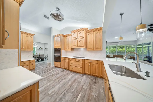 a kitchen with stainless steel appliances granite countertop a sink and cabinets