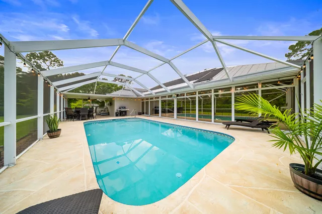 a view of a swimming pool with a yard