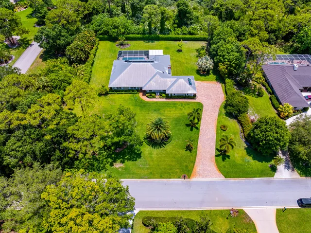 an aerial view of a house with outdoor space swimming pool