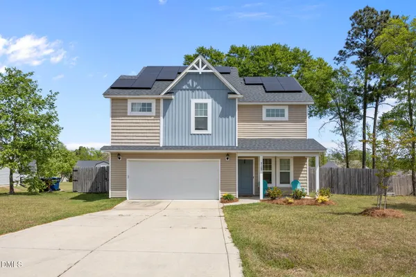 a front view of a house with a garden