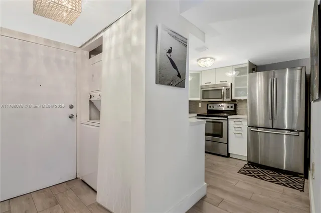 a kitchen with stainless steel appliances a refrigerator and a stove top oven