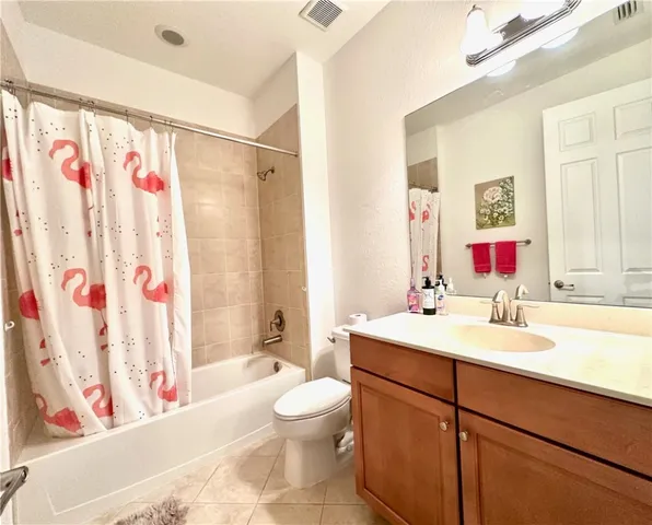 a bathroom with a sink a toilet and a shower curtain