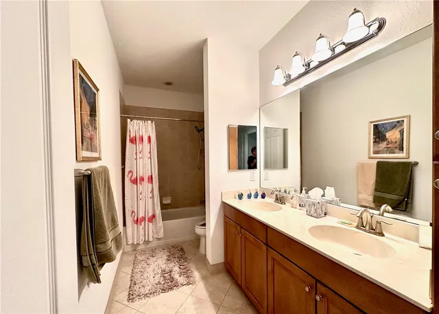 a bathroom with a double vanity sink and a mirror