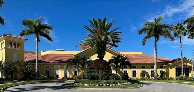 a front view of a building with palm trees