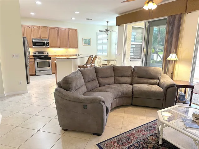 a living room kitchen with furniture and a large window