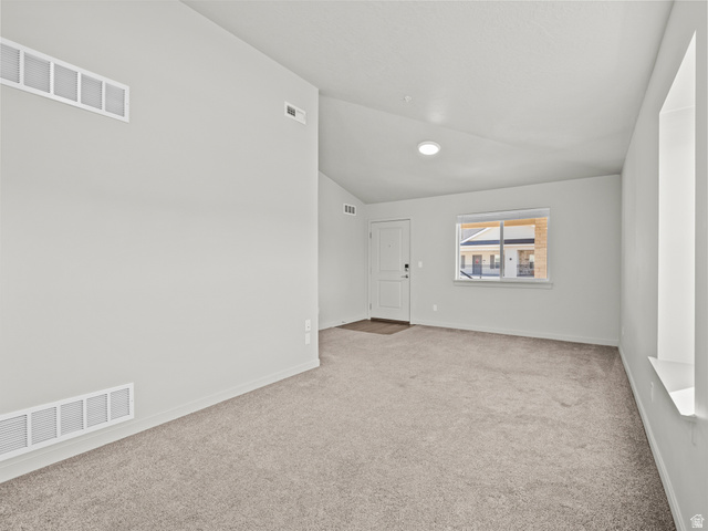 64 West 600 South, Unit C301 Springville, UT 84663 - Photo 10 of 40 Spare room with vaulted ceiling and light carpet