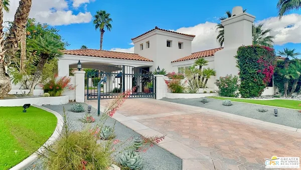 a view of a house with swimming pool and a yard