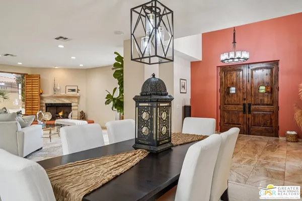 a living room with furniture a fireplace and kitchen view