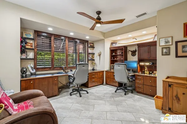 a view of a livingroom with workspace and a window