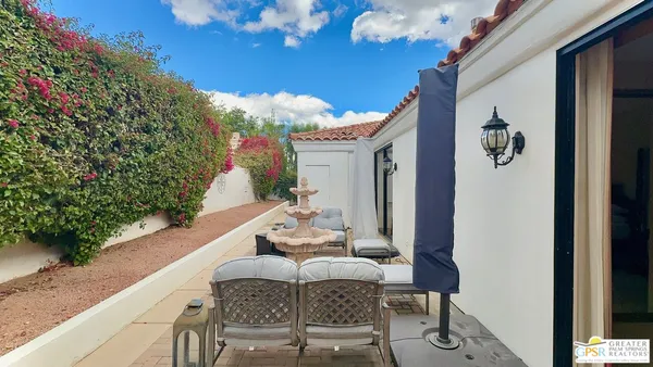 a balcony with table and chairs